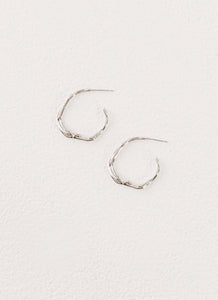 Womens Etta Hoop Earrings in the colour Silver in front of a light grey background