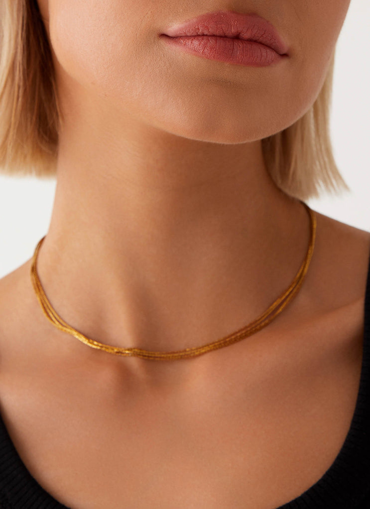 Womens Head Held High Necklace in the colour Gold in front of a light grey background