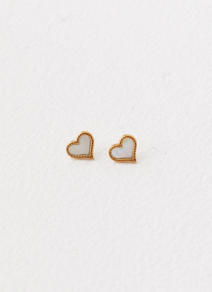 Womens Lois Heart Earrings in the colour Gold in front of a light grey background