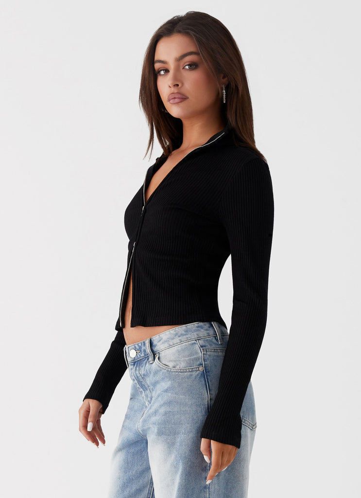 Womens Barbara Long Sleeve Top in the colour Black in front of a light grey background