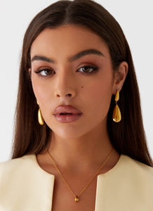 Womens Stay True Earrings in the colour Gold in front of a light grey background