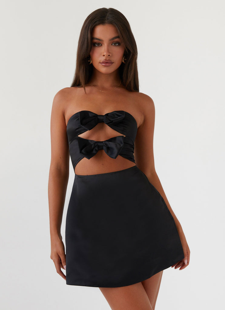 Womens Girl Crush Bow Mini Dress in the colour Black in front of a light grey background