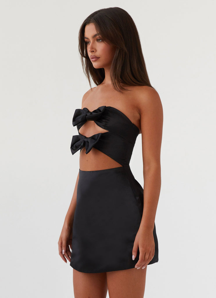 Womens Girl Crush Bow Mini Dress in the colour Black in front of a light grey background