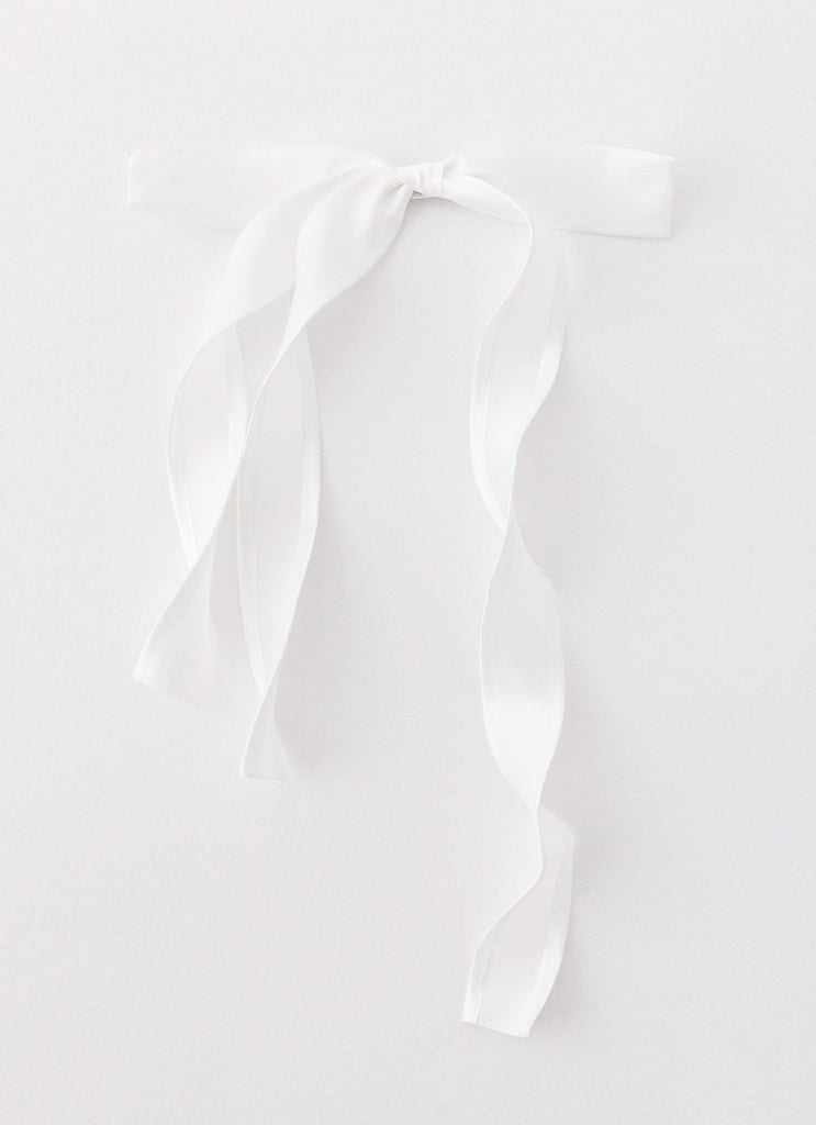 Womens Tied Up Bow Hair Clip in the colour White in front of a light grey background